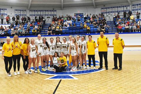 Justin Fitzgerald/sports@cherokeescout.com Murphy girls basketball players and coaches celebrate after winning the 27th annual Battle of the States Tournament last week.