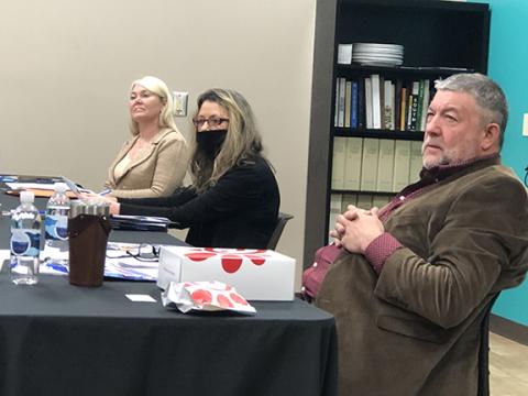 Photos by Abigail Hickman/Staff Correspondent Dr. Donna Tipton-Rogers, president of Tri-County Community College, assistant Kimberly Kilpatrick and Chair Larry Kernea listen at the board of trustees meeting Thursday.