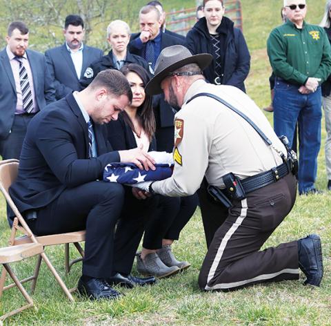 Jared Putnam/editor@cherokeescout.com  Detective Caleb Stiles and his family are presented with the U.S. flag that lay atop Bane’s coffin Monday afternoon.