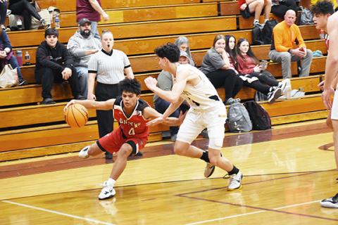 Justin Fitzgerald/sports@cherokeescout.com Kegan Ellis of Andrews tries to fool a Hayesville defender during the Wildcats’ 66-53 loss to the Yellow Jackets on Feb. 14.