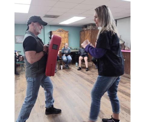 Amanda Hamby/Contributing Photographer Daphne Blount practices punching a target held by Tommy Jackson on Jan. 25 at Penland Senior Center.