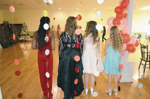 Photos by Abigail Hickman/Staff Correspondent Seventh-graders (from left) Patient Garret (13), Grace Moore (12), Charlie Stalcup (13) and Kenneey White (13) dazzle the ballroom on Main Street in Andrews upon their entrance Saturday.