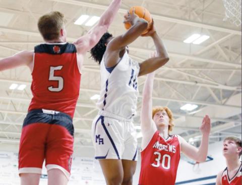 Cory Smith/Mount Airy News Mount Airy’s Tyler Mason rises to the rim as Andrews’ Isaac Weaver (5) and Andy Tatham try to disrupt his shot during the Wildcats’ 69-49 loss to the Granite Bears in the first round of the state 1A playoffs on Feb. 22.
