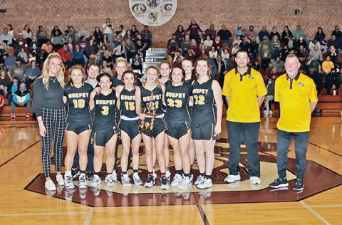 Dave Guffey/Contributing Photographer The Murphy junior varsity girls basketball team beat Swain County 26-21 on Feb. 17 to win the Big Smoky Mountain Conference Tournament championship. Members of the team are: front row (from left), junior varsity head coach Jordan Lovingood, Carson Lovingood, Isabel Parker, Cayla Geer, Julia Dockery, Saige Kent and Madison Stiles; back row (from left), assistant coach Cody Webb, assistant coach Holly Gutierrez, Breeze Hinton, Graceland Worley, varsity head coach Ray Guti