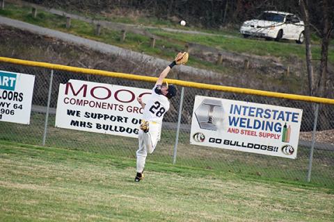 Justin Fitzgerald/sports@cherokeescout.com Murphy outfielder Isaac Cole can’t quite chase down a fly ball during the Bulldogs’ 3-1 loss March 11.
