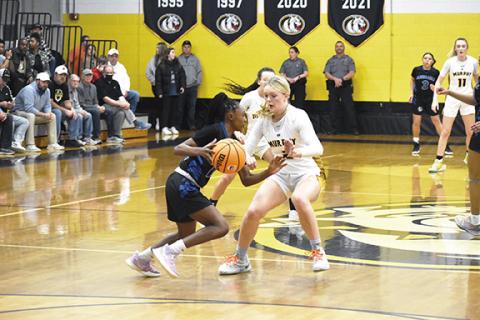 Justin Fitzgerald/sports@cherokeescout.com Murphy’s Lochlan Rogers tries to keep Albemarle’s Amari Baldwin in front of her during Murphy’s 66-36 win over Albemarle in the third round of the state 1A playoffs Saturday. Rogers had a career-high 13 points in the win.