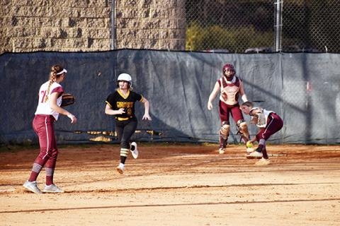 Justin Fitzgerald/sports@cherokeescout.com Murphy’s Ansley Hogsed sprints down the first-base line to try to beat the incoming throw from Swain County’s Hannah Shuler during the Lady Bulldogs’ 9-2 win over the Lady Devils on Thursday.