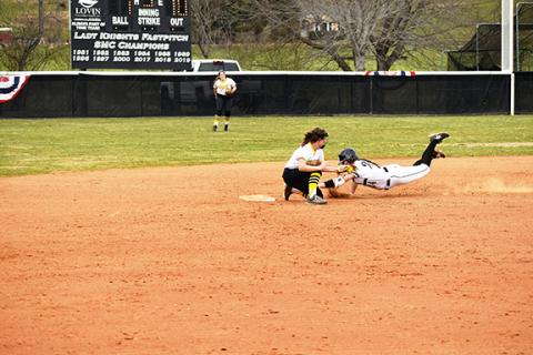 Justin Fitzgerald/sports@cherokeescout.com Murphy’s Ruby Boehm tries to lay down the tag on Robbinsville’s Ivy Odom during the Lady Bulldogs’ 12-1 loss to the Lady Knights on March 22.