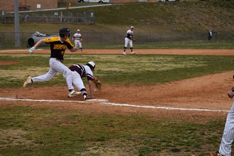 Justin Fitzgerald/sports@cherokeescout.com Murphy’s Braden Rumfelt sprints down the first-base line March 15 as the ball trickles out of Swain’s Charlie Collins’ glove during the Bulldogs’ 4-3 loss to the Maroon Devils.