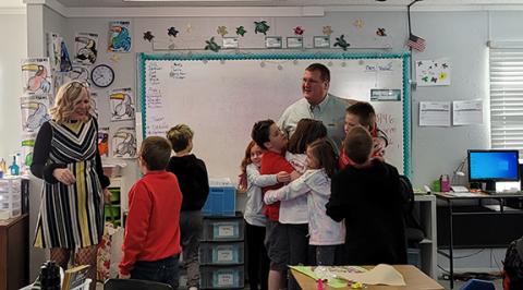 Cherokee Scout Staff Correspondent Abigail Hickman assists Murphy Mayor Tim Radford as part of the Rotary Reads service program Friday morning at The Learning Center charter school.