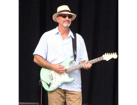 Arleen Elliott/Contributing Photographer David Bellino, now of Murphy, plays his guitar in style at Waikiki Shell in Hawaii.