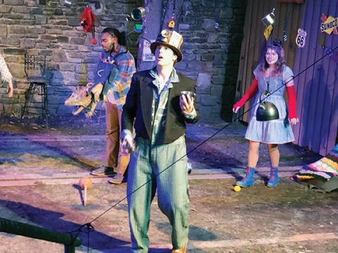 Photos by Abigail Hickman/Staff Correspondent Jon Myer as the Mad Hatter juggles with Bailey Frankenburg (Alice) and Barry Westmoreland (Possum) at the madcap tea party.