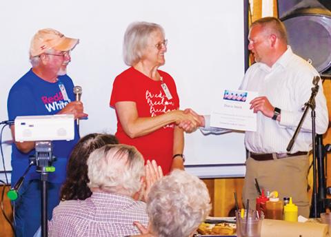 Sam Jokich/Staff Correspondent Dan Adams and Penny Johnson with Citizens for a Better America present an award to Cherokee County sheriff-elect Dustin Smith on Thursday during the group’s monthly meeting at Rib Country in Murphy. The group raised $149 to pay for Smith to attend Sheriff Mack’s Constitutional Sheriffs & Peace Officers Association online class training. For details, visit www.cspoa.org. Smith thanked everyone for their support. Johnson said it’s “important for our county to have a constitution