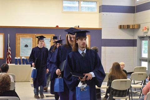 Justin Fitzgerald/sports@cherokeescout.com Aiden Pendergrass leads his fellow Oaks Academy graduates at the end of their commencement ceremony Thursday morning in Marble.