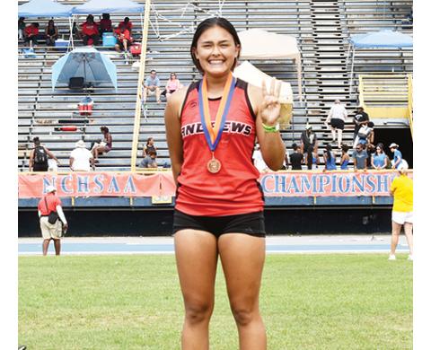Andrews senior Kaylin Ellis was all smiles after receiving her medal for placing third in the 100-meter hurdles.