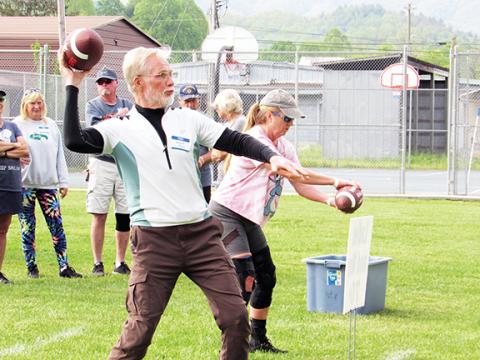 Dwight Moss and Lisa Sellers try their hand at the football target.