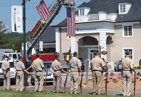 Photos by Jared Putnam/ editor@cherokeescout.com  A large U.S. flag hung from atop a fire truck ladder on Monday in Murphy, as multiple veterans organizations participated in the annual Memorial Day ceremony in the downtown park.