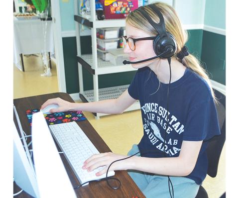 Photos by Abigail Hickman/Staff Correspondent Riley Thompson (13) sits at the Bridges to Learning Tutoring Center’s multi-model teaching computer.