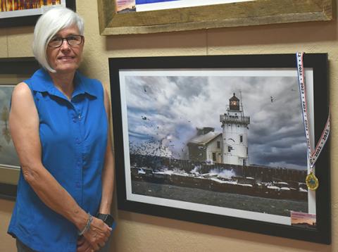 Photos by Bill Belian/Contributing Photographer  Kelly Kennon won the gold medal for her photo titled “Lighthouse in the Storm.”