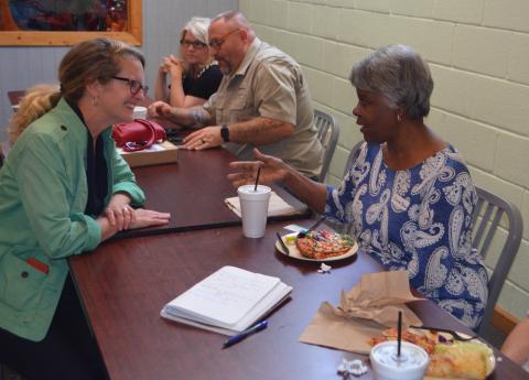 Terri Wells, assistant secretary of the Texana Community Development Club, talks about WNC Communities & Agriculture Programs on June 20 at Downtown Pizza.