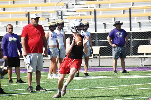 Justin Fitzgerald/sports@cherokeescout.com Everett Tatham looks for an open Andrews receiver during a scrimmage against Union County on June 16.