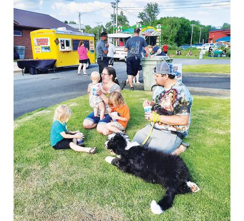 Bill Belian/Contributing Photographer  The Olsen family enjoyed food and music on the grass with their dog, Gypsy, at Food Truck Friday on May 20.