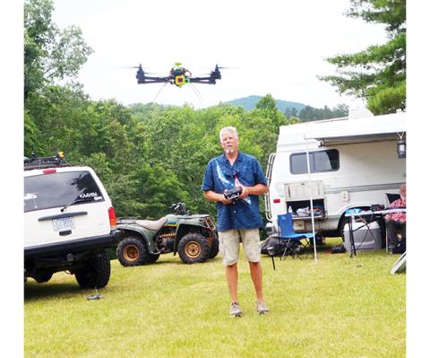 Carl Saylor controls his sophisticated drone Saturday during the Western Carolina Amateur Radio Society’s annual Field Day at Fields of the Wood.