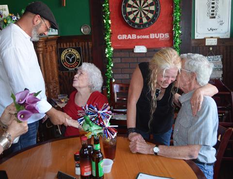 Groom Colby Beck greets his soon to be mother-in-law, Nancy Board, while bride Jamie Glandt receives a blessing from her father, Edward Board, on June 22.