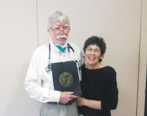 Dr. Brian Mitchell, with his recently awarded the prestigious Order of the Long Leaf Pine award, and Nancy Troxler celebrate the high honor. Mitchell has served Cherokee and Clay counties for more than 40 years.