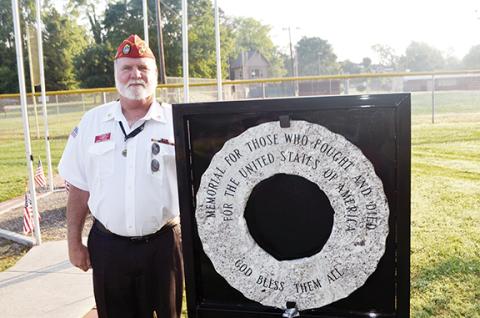 Abigail Hickman/Staff Correspondent George Bendzen of the U.S. Marine Corps League, Cherokee Detachment 1011, stands next to the new granite wreath at Konehete Park in Murphy on Memorial Day. Chaplain J.D. Baker wrote the inscription: “Memorial for those who fought and died for the United States of America, God bless them all.”