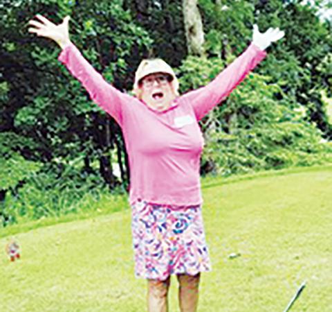 Susan Carmichael celebrates after making a hole-in-one on No. 17.