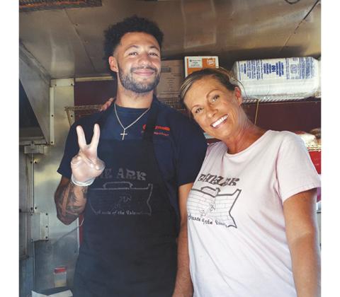 Abigail Hickman/Staff Correspondent Owner Lisa McPhee with “angel worker” Abram Abling inside The Ark food truck at Tasty Tuesday in Murphy.