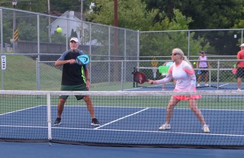 Patricia McGraw and Frank Bachteler eye the ball during their Sunday morning pickleball match on the courts at Konehete Veterans Park in Murphy.