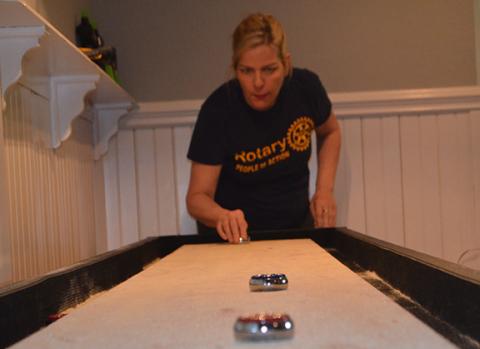 Abigail Hickman plays a competitive game of shuffleboard far from her home in Murphy. In a bout of homesickness, she lost the game, although her competitors pointed to her questionable skills rather than longing for home.