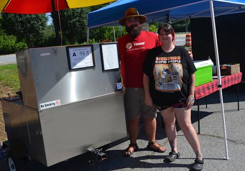 Sweet Pigs Hot Dog & Catering food truck founder Briann Beigel and business associate Sam Summerhill find relief from the summer heat under their umbrella during Murphy’s first Tasty Tuesday event on July 12.