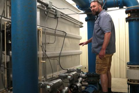 Andrews water plant operator Pete McNeely discusses valves that have been replaced.