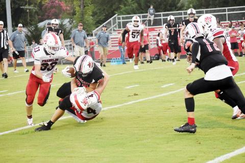 Andrews’ Cole Anderson is brought down by Franklin’s Ben Waldroop during the Wildcats’ scrimmage with the Panthers on Aug. 12. Andrews opened its season with a 42-14 win over the Hickory Hawks last week and hosts East Henderson on Friday night.