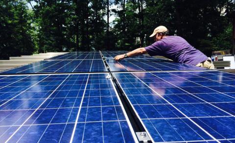 An installer with Carolina Mountain Solar in Murphy works to equip a home with solar panels in a new age of alternative power.