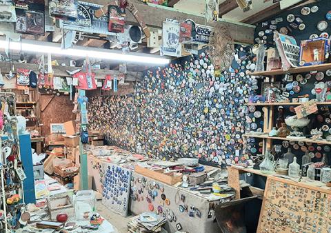 “Ponytail Mike” has walls of old buttons, pins and patches for collectors.