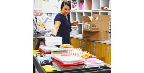 Allison Brown sorts out classroom supplies for students in preparation for the new school year.