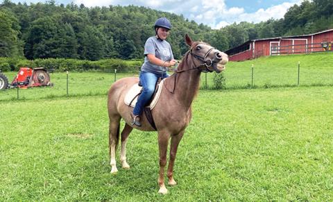 Emma Johnson enjoys a ride at High Lonesome Therapeutic Equestrian Center, one of two Organizations of the Year named by the Cherokee County Chamber of Commerce.
