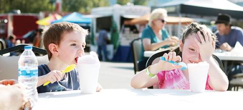 Photos by Jared Putnam/ editor@cherokeescout.com Jesse Barlow and Winter Finch enjoy icy treats Friday during the opening day of the Cherokee County Fair