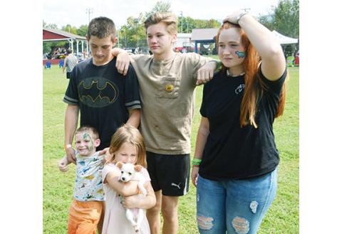 Abigail Blythe Batton/Staff Correspondent Chandler Strickland, 16 – with friend Aiden Hines, 16, and Mariah Strickland, 15 – hang out with little ones Kason Strickland, 3, and Neveah Strickland, who is holding Elsa, their chihuahua schnauzer mix puppy, at the Cherokee County Fair on Sept. 24.