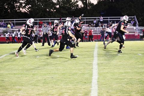 Justin Fitzgerald/sports@cherokeescout.com Andrews’ Austin Martin runs down the field after intercepting a pass, while a host of Wildcats lead the way Friday night in a 62-0 home victory over the North Georgia Falcons.