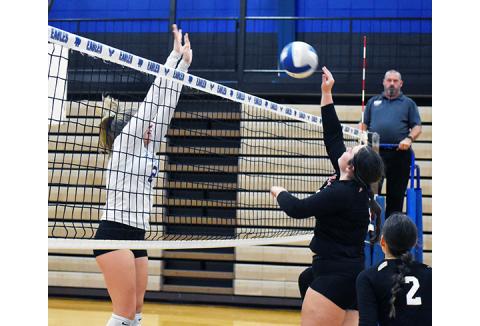 Justin Fitzgerald/sports@cherokeescout.com Andrews’ Carley Clark tries to get the ball over the outstretched arms of Hiwassee Dam’s Olivia McNabb during the Lady Wildcats’ sweep Thursday.
