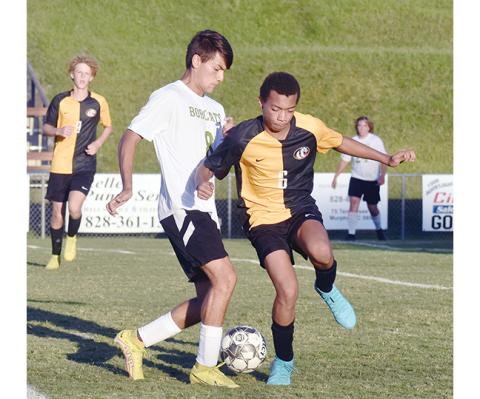 Justin Fitzgerald/sports@cherokeescout.com Murphy’s Keishon Oliver tries to get the ball away from Blue Ridge’s Isaiah Palestino during the Bulldogs’ 4-0 loss to the Bobcats on Sept. 14.