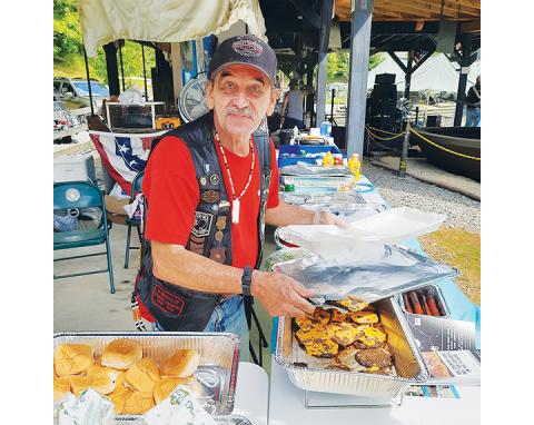 Photos by Anngee Quinones-Belian/Staff Correspondent  Richard “Two Feathers” Texeira is happy to serve up eats and drinks during the annual fundraiser at Band of Brothers Veterans Park on Aug. 20.