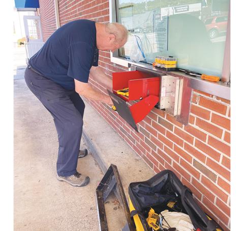 Valley River Arts Guild members Rich Gensheimer (removing the drive-through teller) and President Debra Vanderlaan (taking down old displays) are remodeling the former Entegra Bank, 12 Peachtree St. in the middle of downtown Murphy, to become the new home of the Valley River Arts Guild’s Murphy Art Center. See the front-page report in the Oct. 12 edition of the Cherokee Scout.