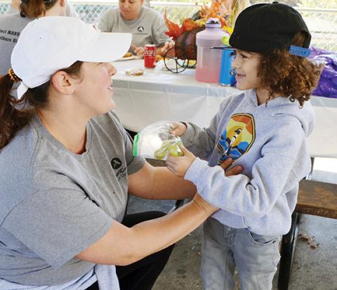 Photos by Abigail Blythe Batton/Staff Correspondent AmeriCorps service member Meghan Watson and her 9-year son, Emory-Kingston Mayberry, help clean up the River Walk at Konehete Veterans Park on Saturday, which was Make a Difference Day in Murphy. 