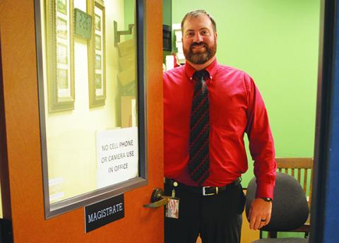Abigail Blythe Batton/ Staff Correspondent Magistrate Judge Josh Postell welcomes the public to his office at the Cherokee County Courthouse in downtown Murphy.